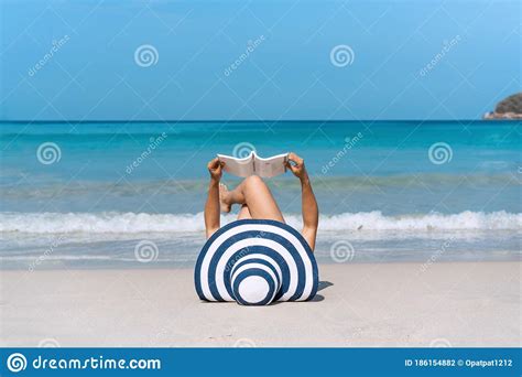 Happy Traveler Asian Woman Lie Down To Reading A Book At Tropical Beach On Vacation Summer On