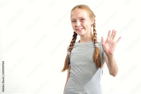 Foto Stock Hello Teen Girl Waving Her Hand In Greeting Portrait Of A