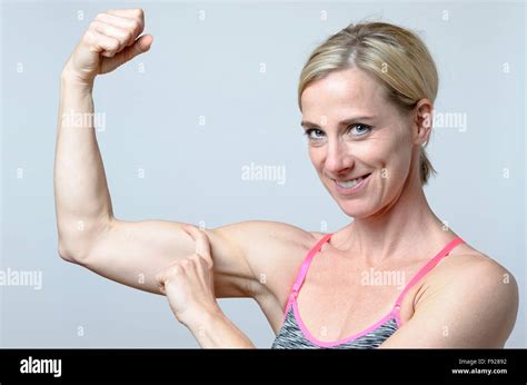 Attractive Smiling Woman Bodybuilder Showing Off Her Biceps As She