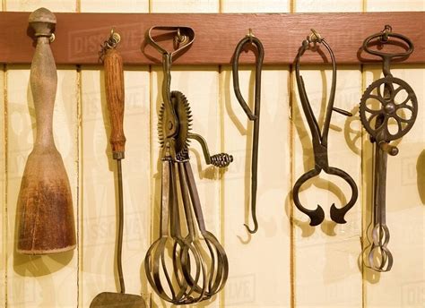 Antique Kitchen Utensils Hanging From Hooks Stock Photo Dissolve
