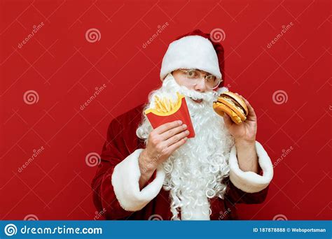 Funny Man In Santa Claus Costume Isolated On Red Background With Fast