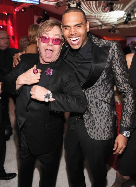 Photos Elton John And Vanity Fair Oscar After Parties With Chris Brown
