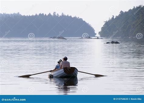 Couple Rowing A Dinghy In Princess Bay Wallace Island Gulf Islands