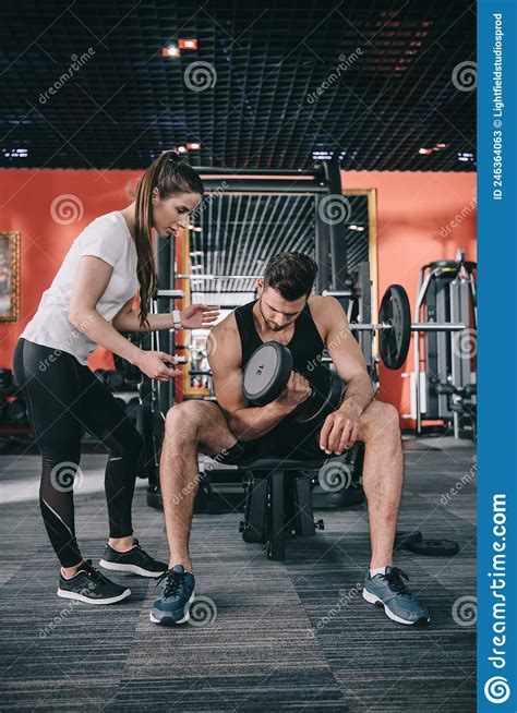 Attractive Trainer Instructing Young Sportsman Working Stock Image