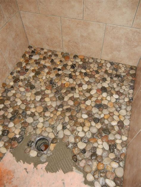 Pebble tile floors are uncomfortable for some people to stand and walk on, and drainage in a shower stall can be a challenge for the amateur installer. Create your own pebble shower floor! - Your Projects@OBN