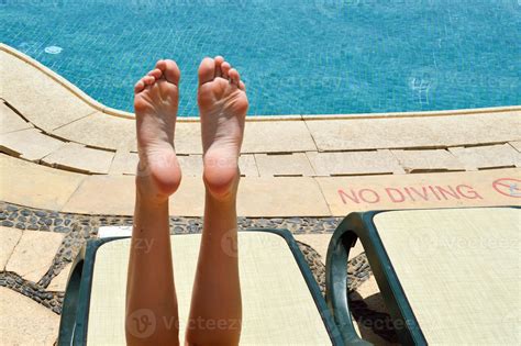 Beautiful Legs Girls Feet Women On The Background Of A Deckchair And