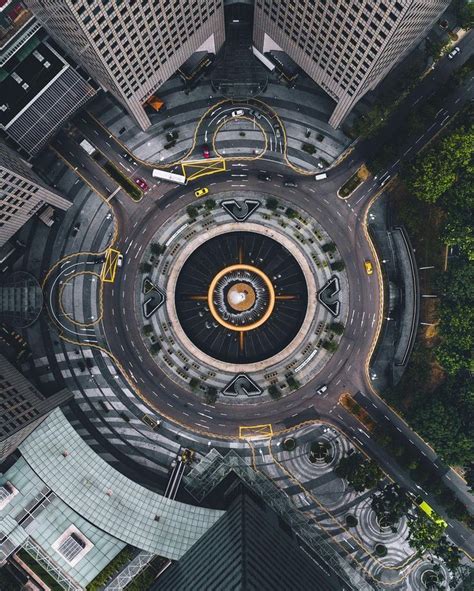 An Aerial View Of A Circular Building In The Middle Of A City With Lots