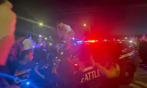 Woman Twerks On Top Of Cop Car In Front Of Jeering Crowd As Seattle