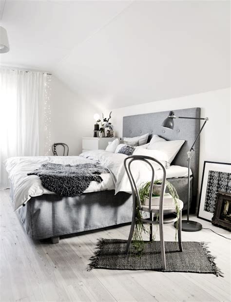 A scandinavian sleeping space with oversized windows, a shelving unit on casters. 74 Cozy And Comfy Scandinavian Bedroom Designs - DigsDigs