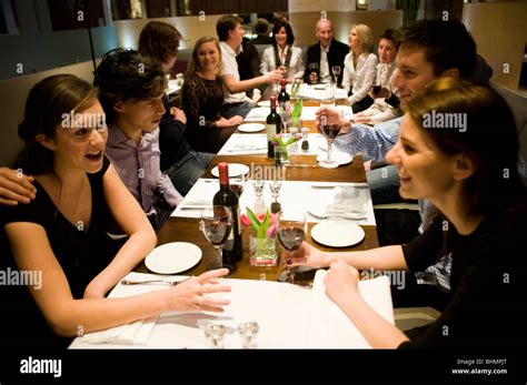 A Large Group Of Young People And Adults Eating In A Pizza Restaurant
