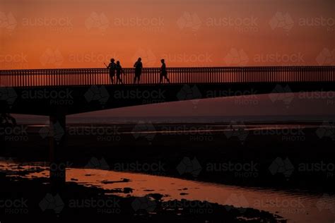 Image Of People Walking Across Bridge At Sunset Austockphoto