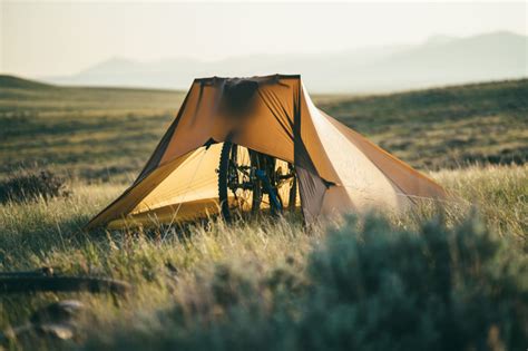 Weigh the canopy down to keep it from blowing away on windy days. Set Up a Tarp Shelter Using Your Bike (Video ...