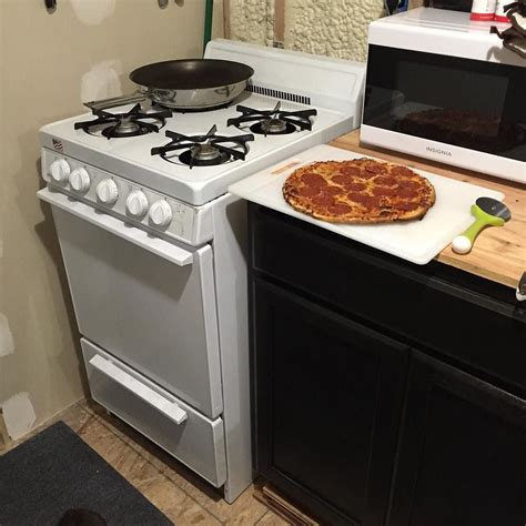 Oven features a surprising amount of cooking flexibility with racks adjustable to five different positions. Cooked a pizza in my tinny tiny oven. #tinyhouseliving # ...