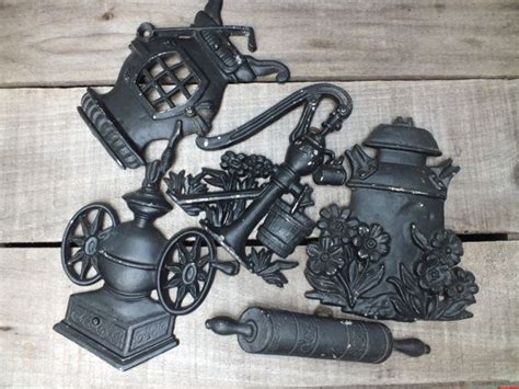vintage cast iron wall hangings made by sexton set of 5 stove rolling pin crock pump