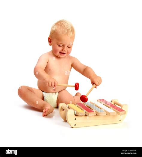 A Cute Baby Boy Playing A Xylophone Musical Instrument Isolated On A