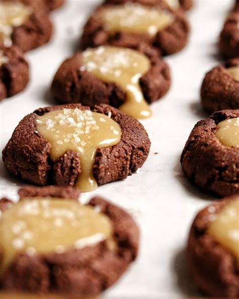 Chocolate Cookies With Caramel Icing Are On A Baking Sheet Ready To Be