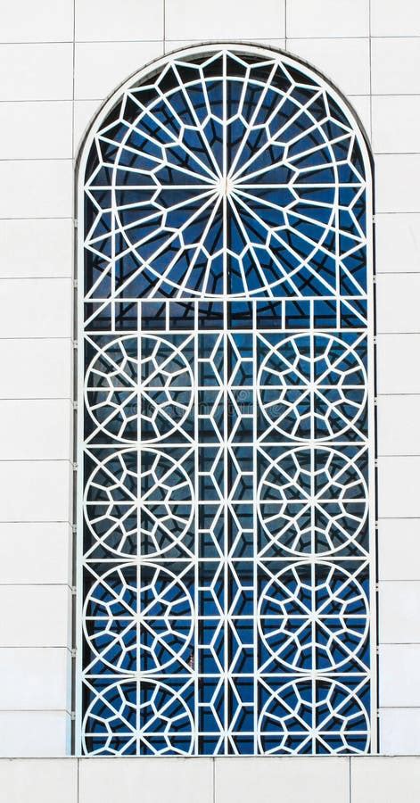 Large Gray Old Window With Ornamental Metal Lattice Of Building Wall