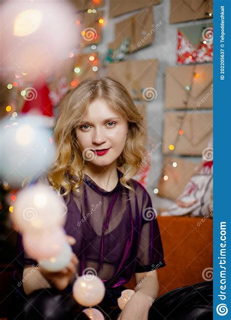 Close Portrait Of A Cute Lady With Christmas Lights Looking At The