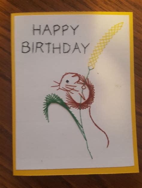 A Happy Birthday Card With A Drawing Of A Mouse Holding A Flower In Its