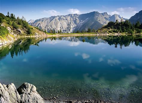 Premium Ai Image Serene Mountain Lake With Crystal Clear Water