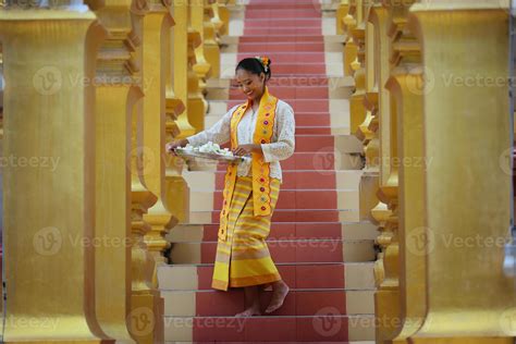 Young Asian Girl In Traditional Burmese Costume Holding Bowl Of Rice On