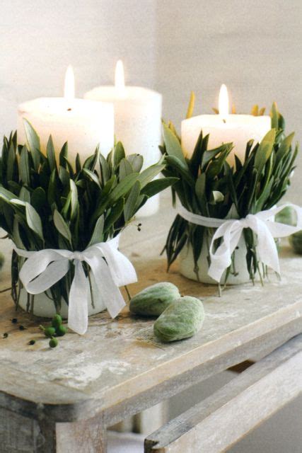 White Pillar Candles Decorated With Olive Leaves And White