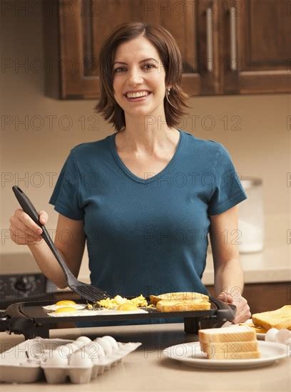 Portrait Of Woman Preparing Breakfast In Kitchen Photo Mike Kemp