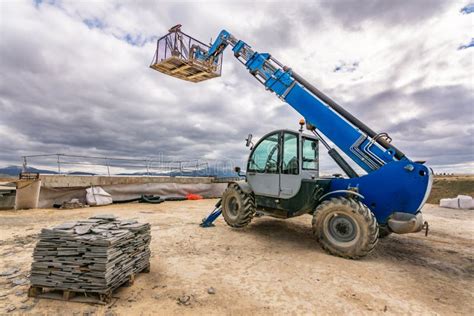 Forklift On A Construction Site Preparing To Raise Construction Parts