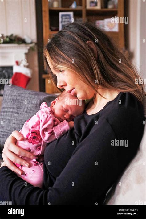 Young Mother Cuddling Her New Born Baby Stock Photo Alamy