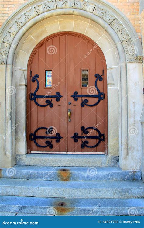 Old Stone Church With Arched Doorway And Ornate Entrance Stock Photo