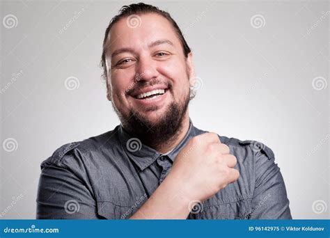 Portret Van De Lachende Jonge Mens Tegen Grijze Muur Het Gelukkige