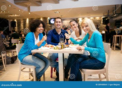 Young People Having Lunch In Restaurant Stock Photo Image Of Girls