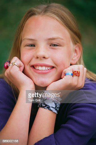 Smiling Girl With Hands On Chin Photo Getty Images