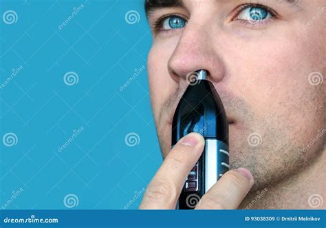 Handsome Young Man Remove Hair From His Nose With Trimmer Stock Image