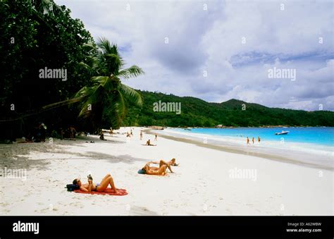 Tourists Relaxing On The Nude Topless Beach Of Anse Lazio Beach In Praslin In The Beautiful