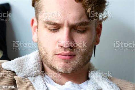 Portrait Of Modern Young Man Looking Down Background With Copy Space