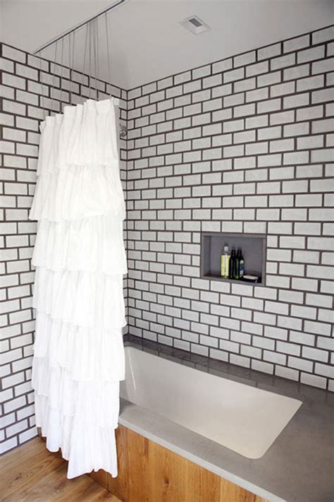 Beveled white subway tile with gray herringbone style beveled white subway tile with gray grout detail. From Tile to Toilets: 10 Modern Bathroom Trends