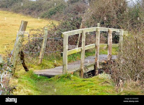 A Rickety Tumbledown Old Wooden Bridge Footbridge On A Country Walkway