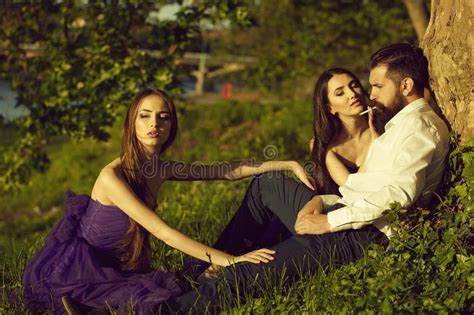 Bearded Man And Two Women On Grass Stock Image Image Of Grass Young