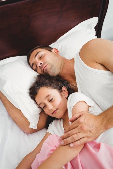 Daughter Sleeping Beside Father On Bed At Home Stock Image Image Of