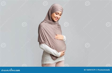 pregnant muslim girl in hijab tenderly touching her belly stock image image of mother happy