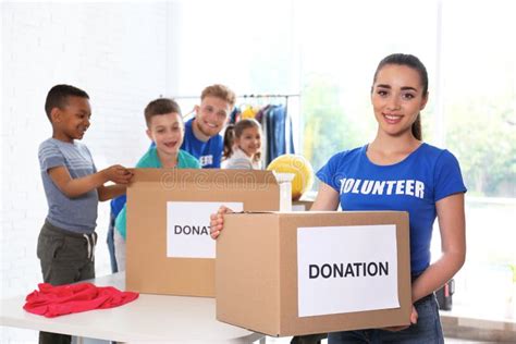 Volunteers With Children Sorting Donation Goods Stock Photo Image Of