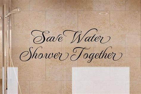 A Bathroom Wall With The Words Save Water Shower Together