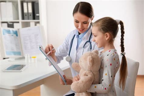 Children S Doctor Working With Little Patient In Clinic Stock Photo