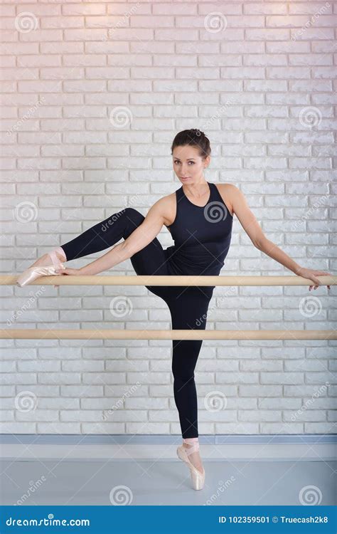 Ballerina Stretches Herself Near Barre At Ballet Studiofull Length