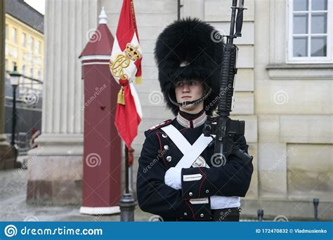 Royal Guard In Uniform Near Sentry Box At Royal Amalienborg Palace In