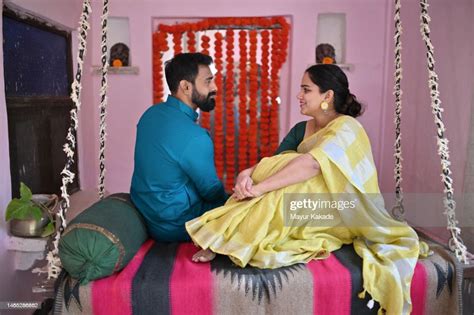 Mature Indian Couple Sitting On A Swing And Spending A Good Time With