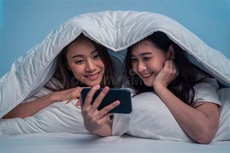 Asian Attractive Lesbian Couple Use Mobile Phone Watch Movie On Bed Beautiful Sibling In