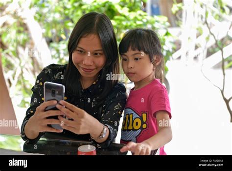 Young Woman And A Little Girl Playing With A Smartphone Lasem Java