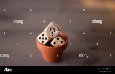 Game Dice With Question Mark In Front Of Wooden Background Stock Photo